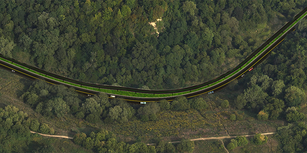 An aerial view of the multi-use trail showing auto transportation and the forest surroundings.
