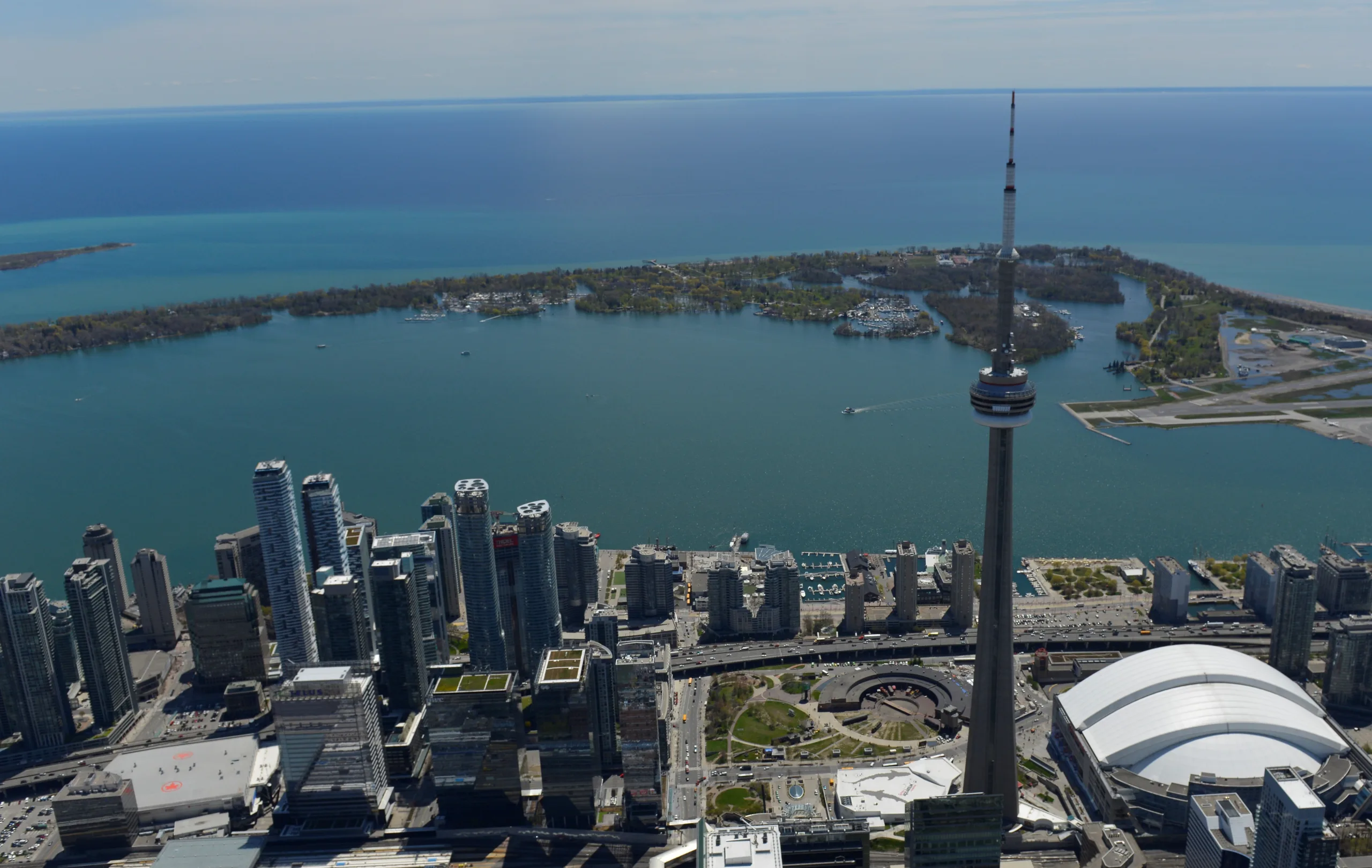 Aerial view of Toronto Island Park from Lake Ontario with Toronto skyline in the background.